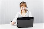 girl with laptop in headphones with a microphone. HotLine