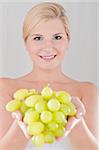 Pretty woman with white grapes