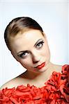 Young elegant beauty female face with red shiny lips and black eye makeup. colse-up.