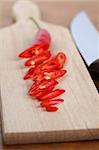 Sliced red chili pepper on a cutting board. Shallow dof