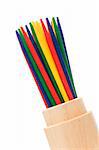 colorful mikado sticks in wood cup on white background