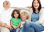 Portrait of a family on the sofa while watching television