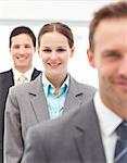 Happy businesswoman standing in a row with her two partners at work