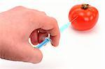 Syringe injecting tomato close up
