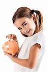 Little girl holding a piggy-bank and inserting a one euro coin