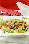 salad with vegetables and meat grilled on a plate