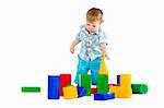 Cute little baby boy with colorful building blocks isolated on white