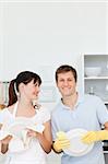 Lovers washing dishes together in their kitchen