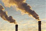 Power plant with smoke under sunset