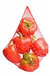 red bell peppers hanging in plastic net