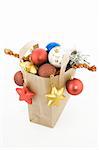 Christmas items in shopping  bag on white background