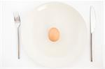 top view of one egg on white plate
