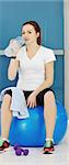 young woman drinking water at fitness workout training at sport club