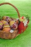 Easter eggs in basket on green Grass