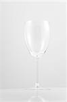 Empty white wine glass on white background