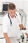 Young blond handsome doctor standing in laboratory