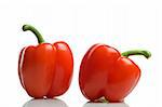 couple of red bell peppers on white background