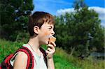 boy eats ice cream in the summer day