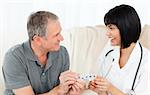 Nurse showing pills to her patient