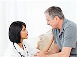 Man talking with his nurse on the sofa