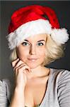 A smiling young girl with a Christmas hat