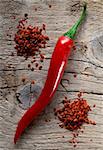 Fresh and coarsely ground Red Chili Pepper on wooden board