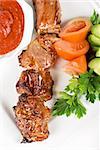 Fried kebab meat with vegetables and sauce