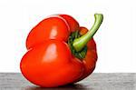 single red bell pepper on white background