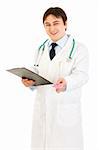 Smiling doctor holding clipboard and prescription drugs in hands isolated on white