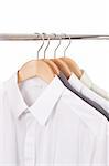 clothes hanger with shirts isolated on white