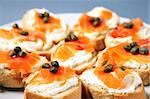 A close-up of traditional jewish sandwiches witsh cream cheese, salmon and capparis