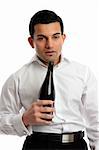 Alcohol abuse.  A drunk man looking very uncoordinated and bleary eyed holding a bottle of wine.  Alcohol affects the brain in the following ways, drowsiness,  loss of balance,  poor coordination,  slower reaction times,  slurred speech,  slowed thought processes,  nausea and vomiting