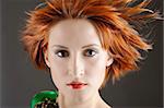 Beauty portrait of pretty woman with healthy red flying hair, pure skin and natural make-up. copy-space