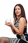 A beautiful young Hispanic Latino ethnic woman drinking coffee.
