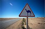 Rare highway warning sign, Western Sahara desert in Morocco.