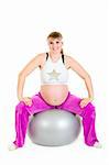 Smiling beautiful pregnant female doing exercises on  fitness ball isolated on white