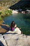 woman on a river at Gredos mountains in Avila Spain