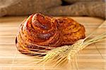Cinnamon rolls with ear of wheat closeup