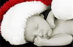 Beautiful Newborn christmas baby wearing a fluffy hat