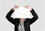 Woman showing a blank paper sheet in front of her head