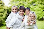 Parents with children on shoulders outdoors