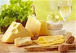 various types of cheese on wooden cutting board