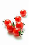 Fresh ripe cherry tomatoes scattered isolated on a white background