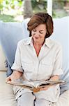 Retired woman reading her book