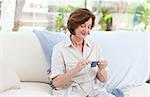 Woman knitting at home