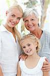 Portrait of a joyful family looking at the camera at home