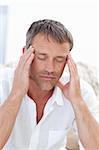 Man having a headache at home