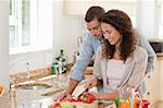 Handsome man cooking with his girlfriend at home