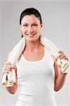 sporty woman with towel on shoulders on grey background