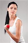 portrait of a sporty woman on grey background